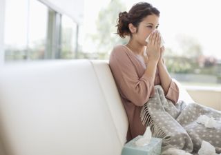 Woman blowing her nose