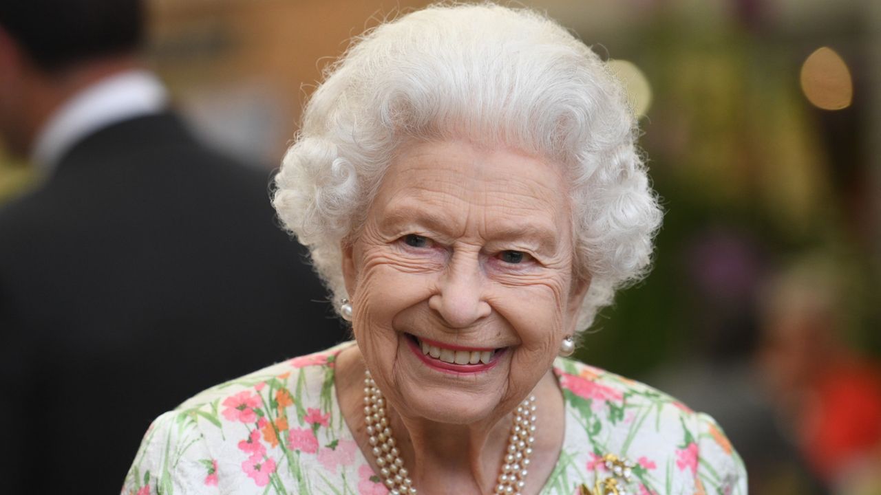 How Queen &quot;kept her spirits up&quot; has been revealed, seen here attending an event in celebration of The Big Lunch initiative 