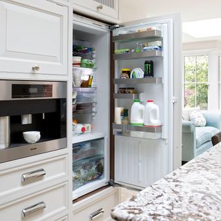 kitchen area with white fridge and coffee machine