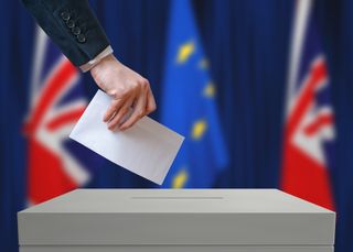 An image of a businessman casting a vote in a referendum on EU membership
