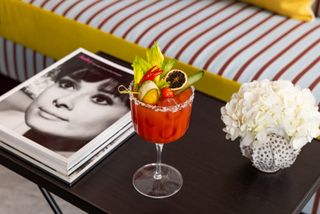 A red cocktail next to a book