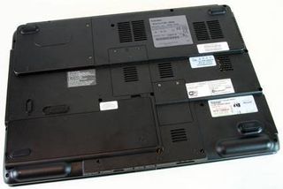 The bottom of the Satellite p105. The battery module is at the bottom left of the photo, above that to the right is the memory cover. The hard drive lives at the top left.