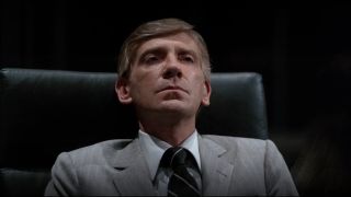 David Warner sits in his office looking annoyed in Tron.