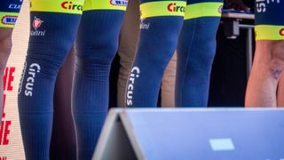 A close-up of the aero leg warmers used by Intermarche-Circus-Wanty as they stand on stage ahead of the race