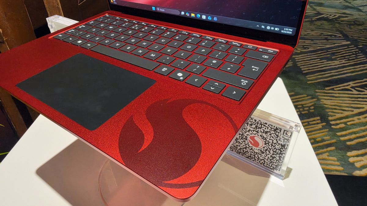Microsoft Surface Laptop 13-inch 2nd Edition with Manchester United and Qualcomm Snapdragon branding on a red chassis, displayed with football imagery