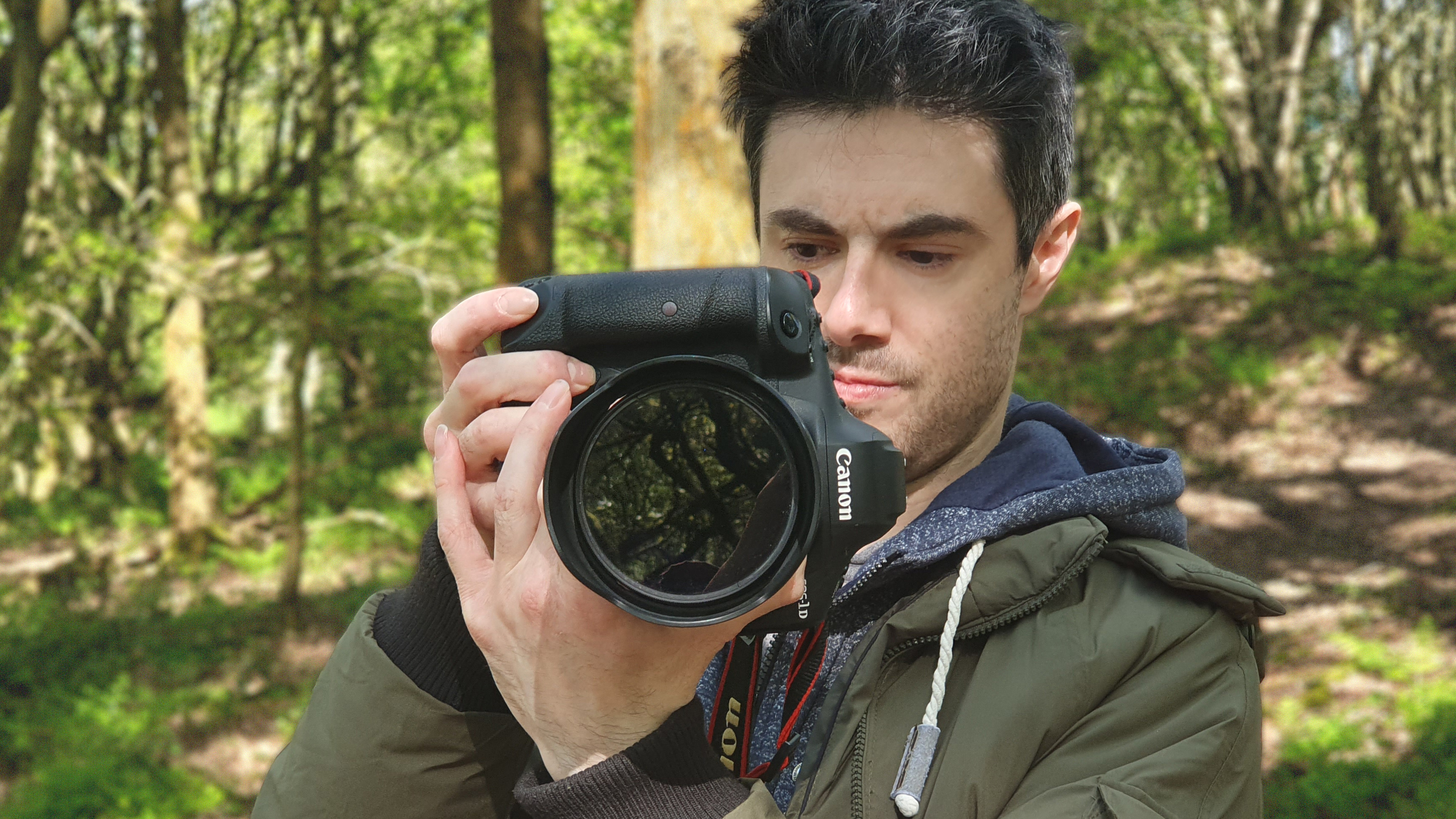 A man holding the Canon EOS 1DX Mark III camera
