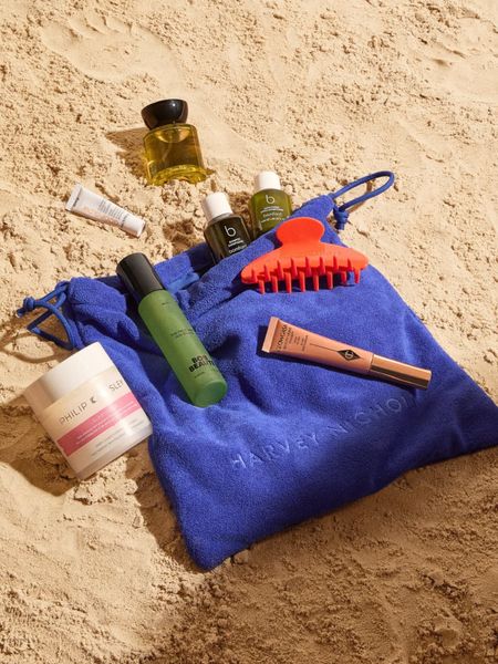 Beauty products on a bag on the sand