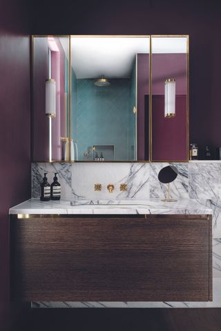 how to use bold color in the bathroom with walnut wood cabinet, purple walls and marble tiles