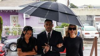 Samantha Logan as Olivia Baker, Michael Evans Behling as Jordan Baker and Monet Mazur as Laura Baker walking in all black to a funeral in All American season 5