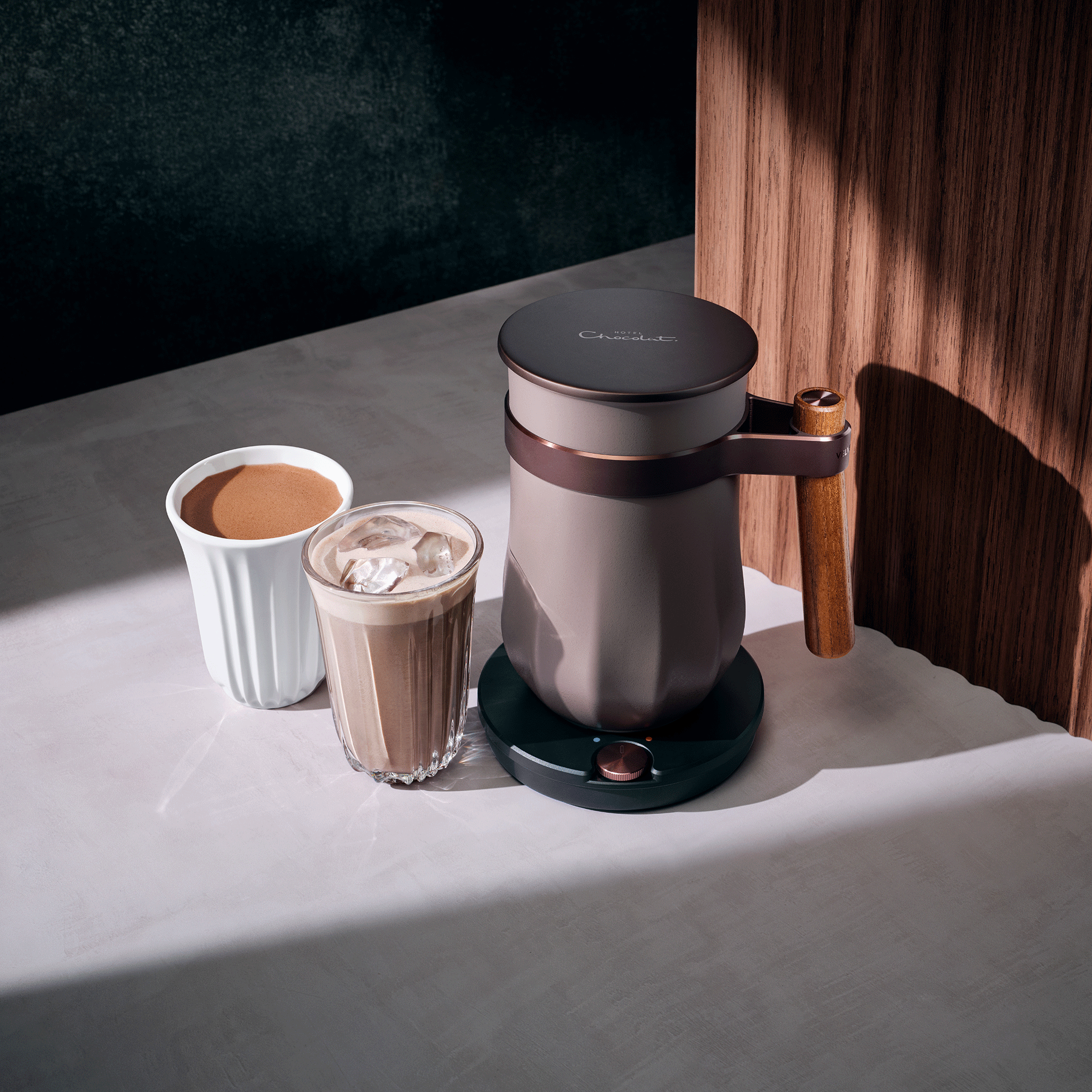 Velvetiser Hotel Chocolat next to a wooden ridge backdrop
