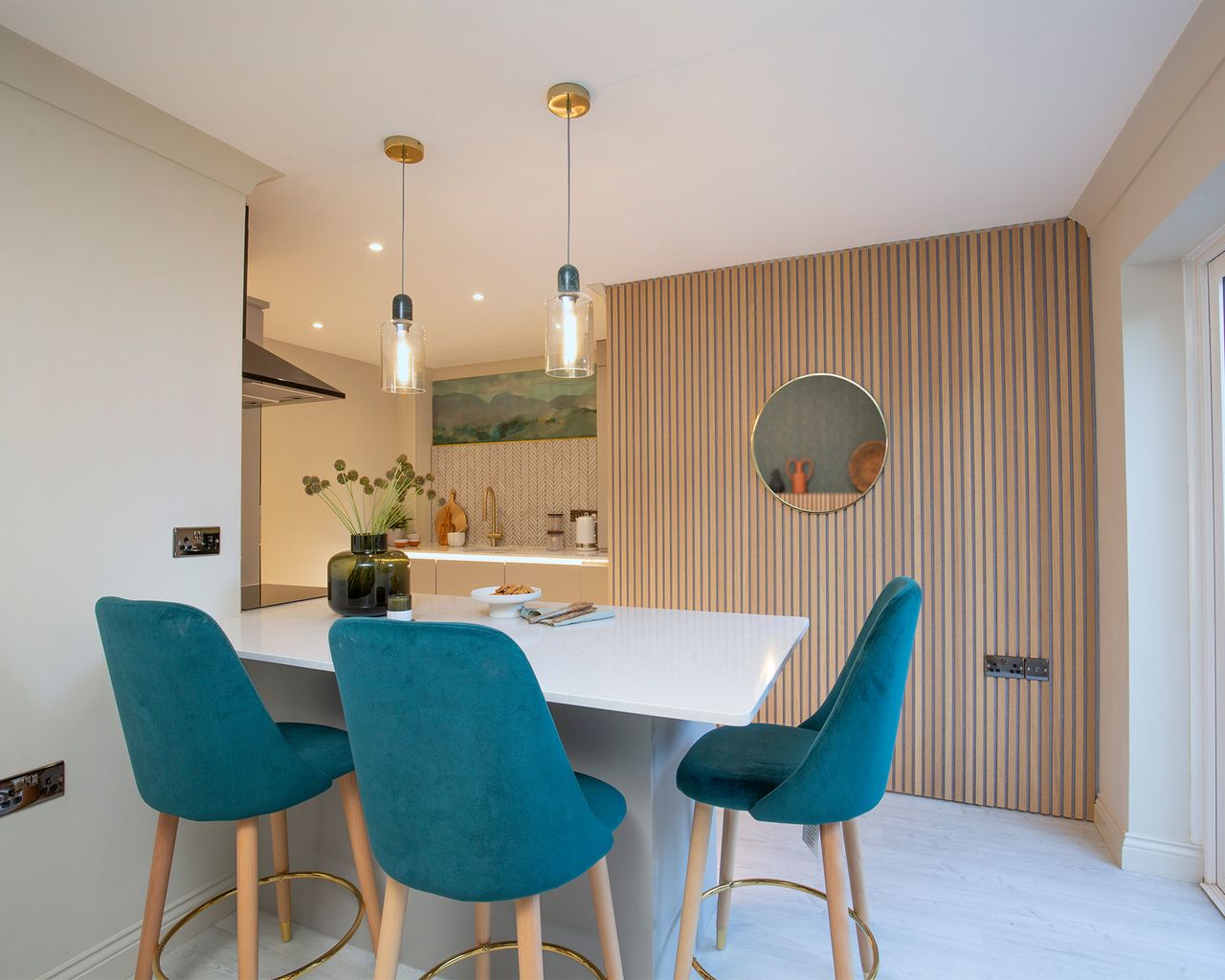 Lighting design in the kitchen with table and blue upholstered chairs