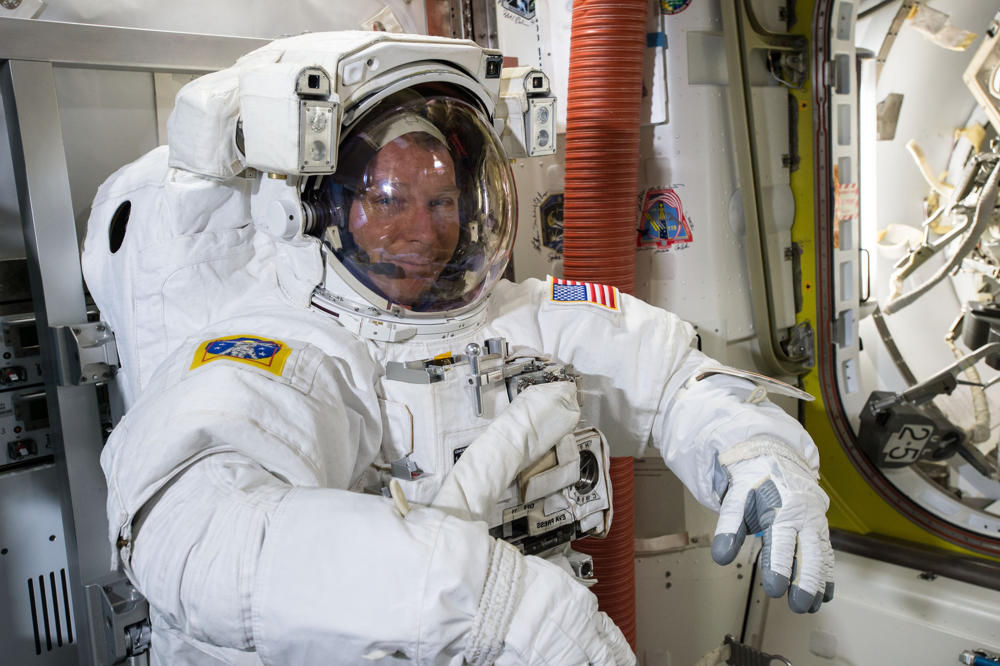 NASA astronaut Terry Virts tries on his spacesuit in preparation for a Feb. 21 spacewalk outside the International Space Station with crewmate Barry Wilmore.