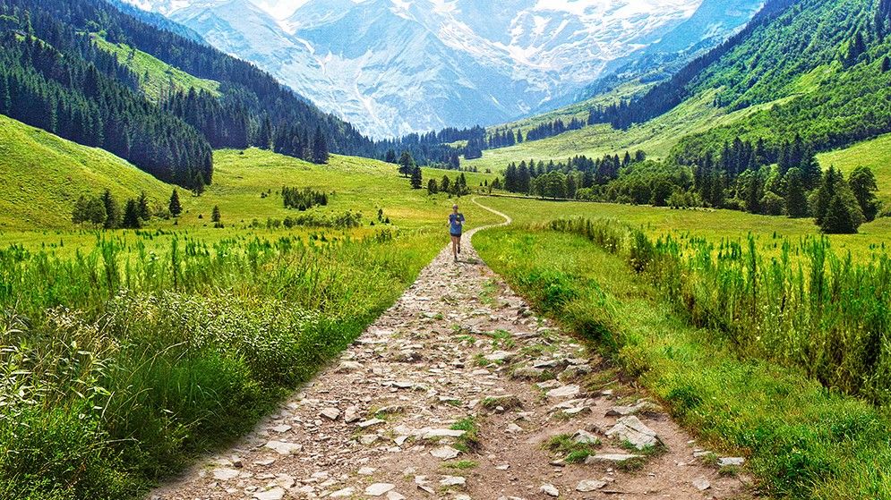 Woman trail running in the mountains