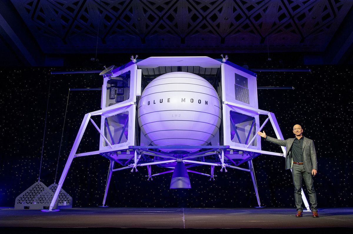 Blue Origin founder Jeff Bezos with a mockup of the company&#039;s Blue Moon robotic lunar lander during its unveiling on May 9, 2019. On Oct. 22, Bezos unveiled new partners for a lander to carry NASA astronauts.