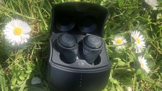 the ath-cks50tw true wireless earbuds in their charging case