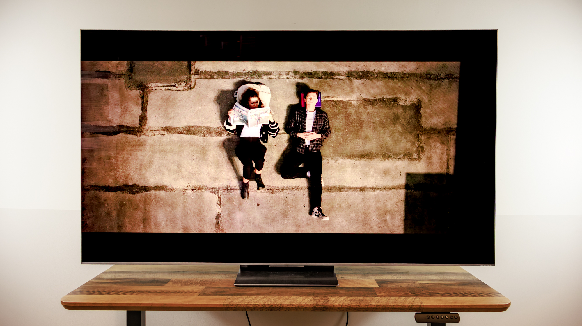 A TCL QM8L TV on a desk