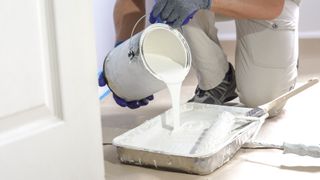 Pouring primer into paint tray