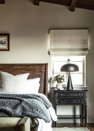Farmhouse bedroom ideas with a wooden headboard and bedside table