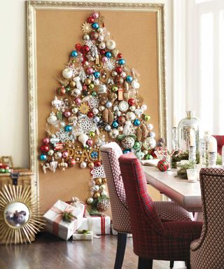 A brass framed picture frame with assortment of different colored and sized bauble decor in dining area with traditional dining table and chairs