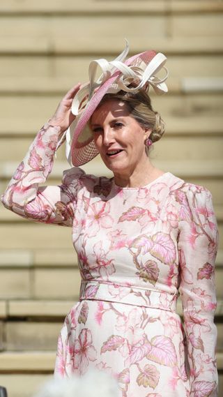 Sophie, Duchess of Edinburgh, holds on to her hat as she leaves following the Order Of The Garter Service