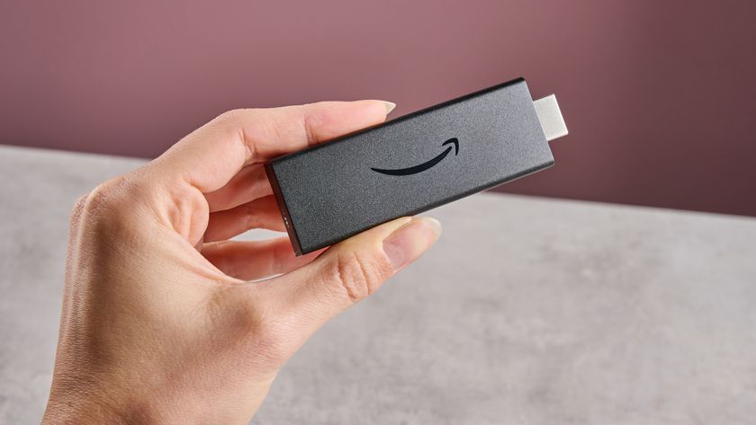 A woman&#039;s hand holds the Amazon Fire TV Stick HD.