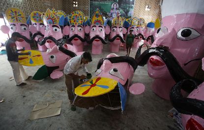 Indian artists prepare effigies of the mythical demon King Ravana.