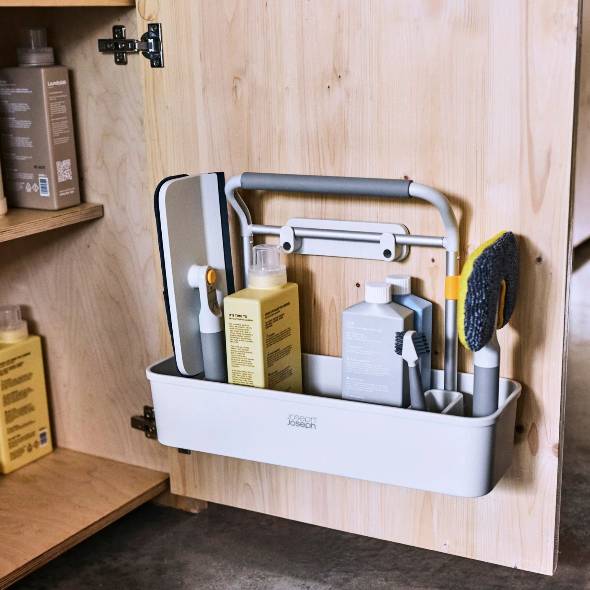 Joseph Joseph CleanTech Caddy attached to a wooden cupboard door