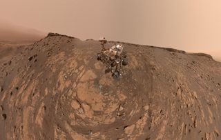 NASA's Mars rover Curiosity snapped this selfie after drilling a hole at a rock feature called "Hutton" and making its way up to the Greenheugh Pediment, the rocky mound seen here behind the rover and to the left. This panorama combines 86 images taken by the Mars Hand Lens Imager (MAHLI) camera on Curiosity's robotic arm on Feb. 26, 2020, the 2,687th Martian day, or "sol," of the rover's mission on the Red Planet.