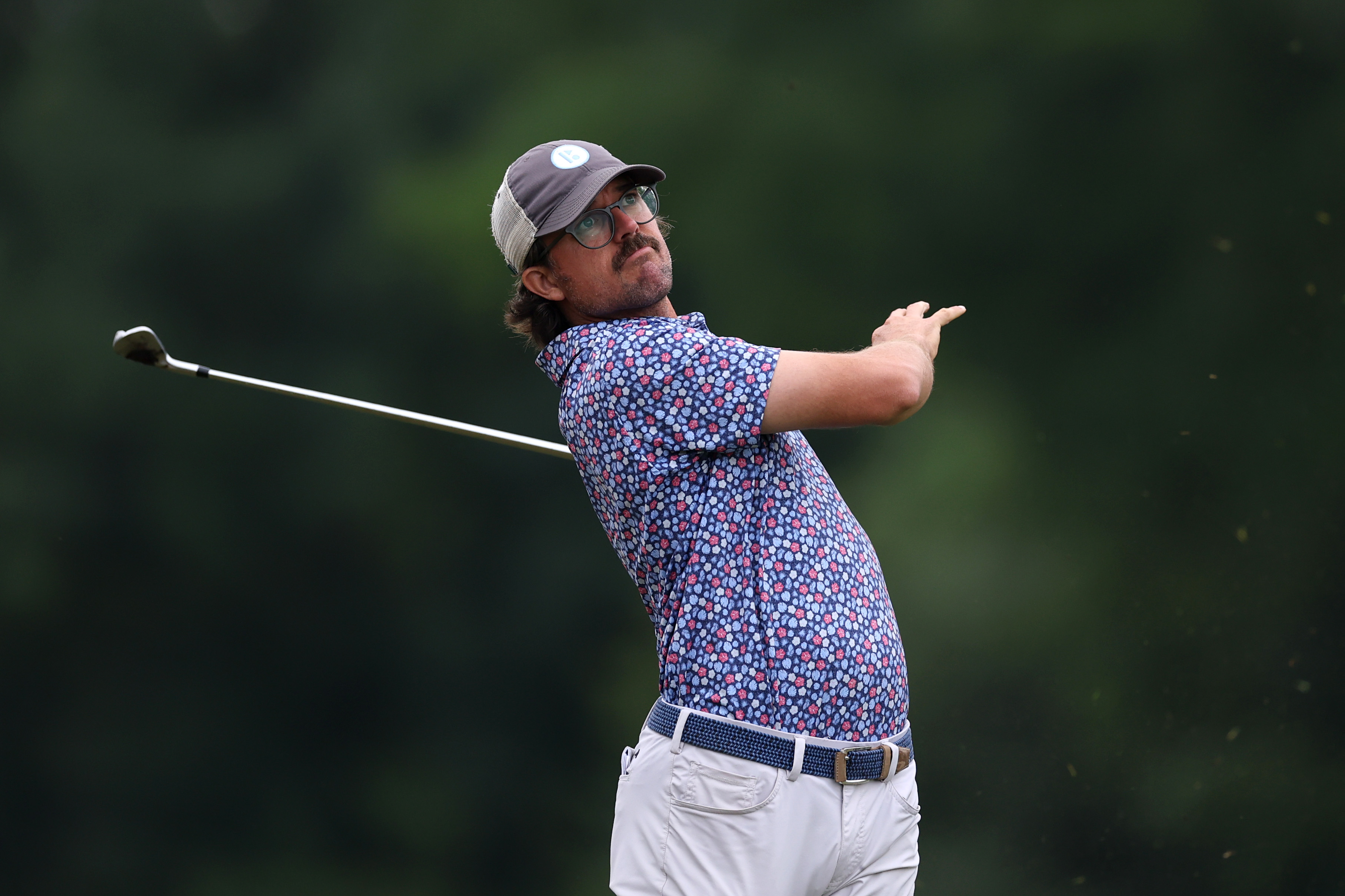 George Bryan hits a shot with his club