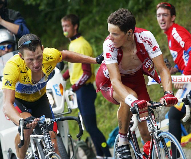 Lance Armstrong lets a young Sylvain Chavanel know that he's there, with the American on his way to winning stage 15 of the 2003 Tour de France to Luz-Ardiden