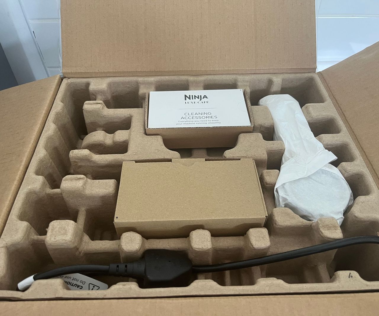 The top of carboard packaging with a ninja booklet on top.