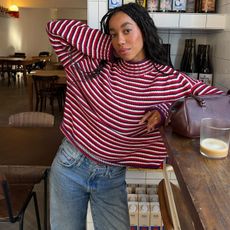 Woman in stripe red J.Crew rollneck sweater and jeans