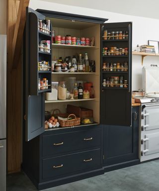 freestanding dark gray/black pantry with open doors showing door storage and inside shelving, two drawers underneath