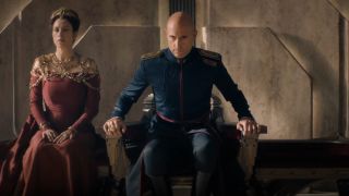 Mark Strong rising from his throne in full regalia in Dune: Prophecy.