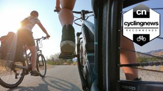 Two people riding co-op cycles electric bikes