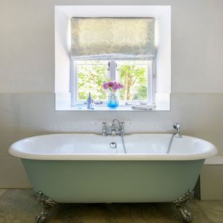 country bathroom with mint roll top bath