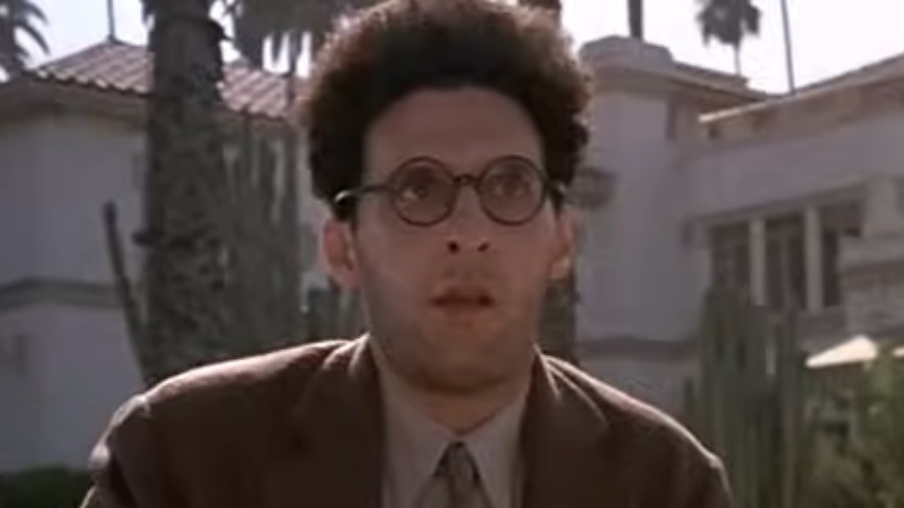 John Turturro wearing glasses outside in Barton Fink