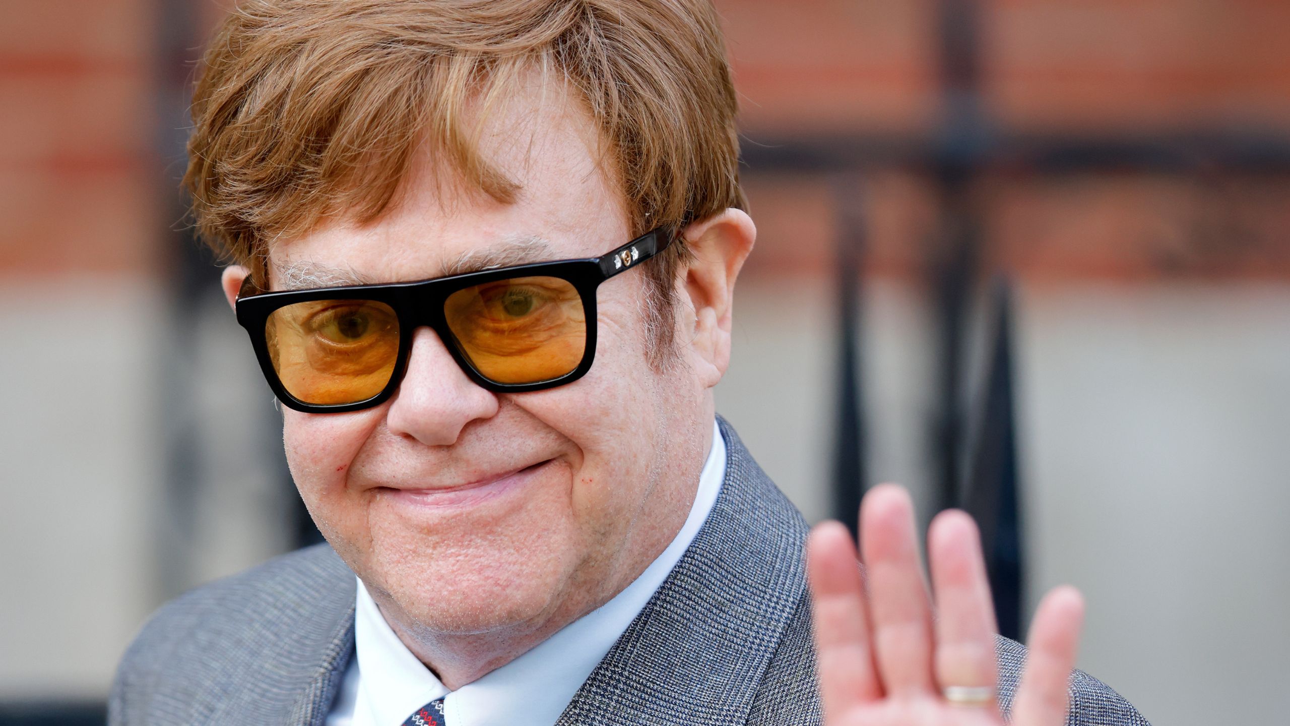 elton john waving at the camera