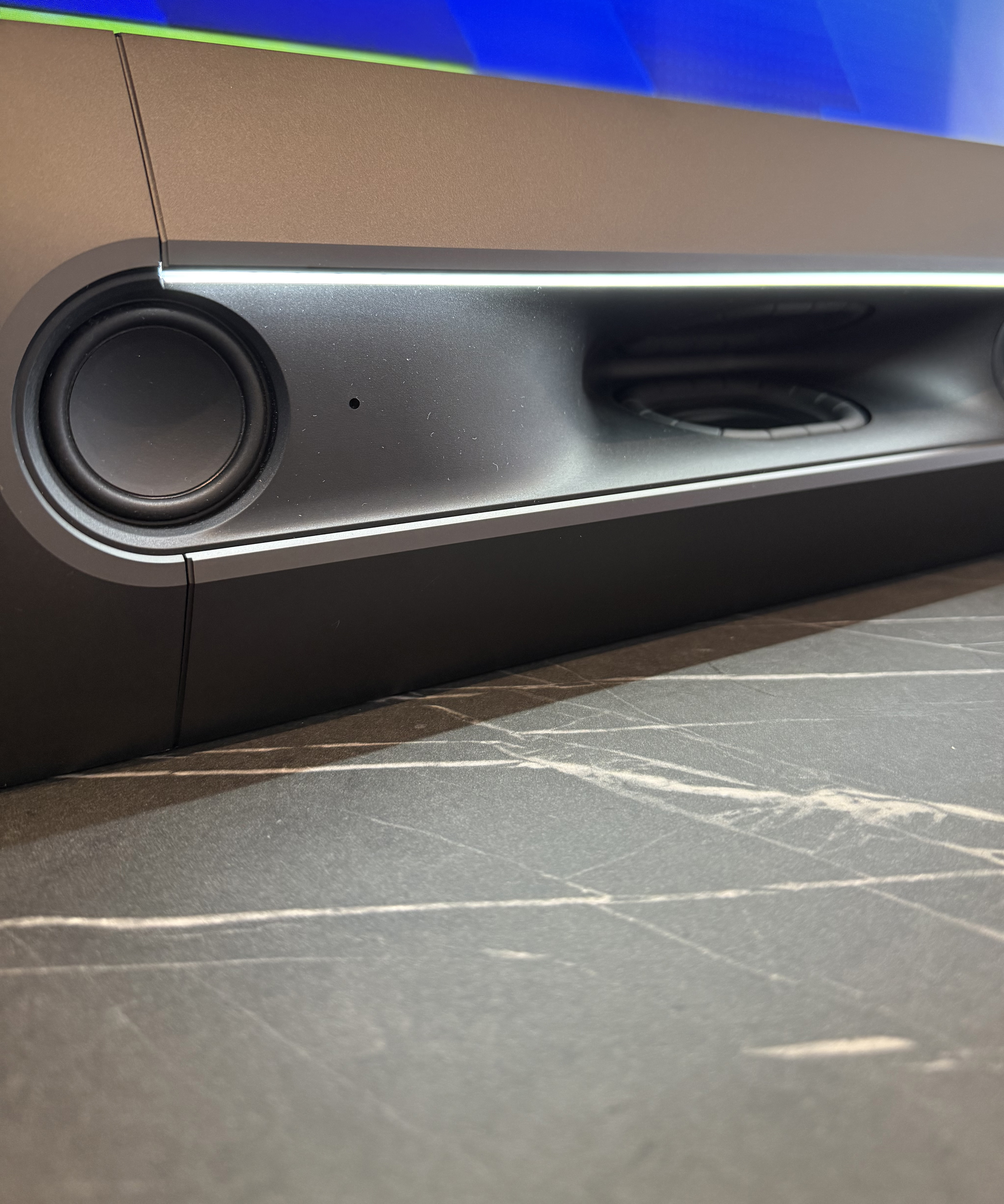 Close-up of the soundbar with subtle ambient lighting along its edge