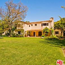 villa with garden lawn and trees