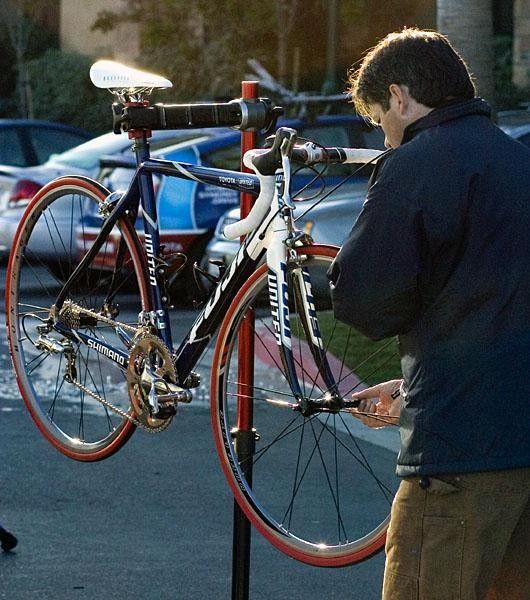 Head mechani Shane Fenon gives one of Toyota United's new Fuji team bikes a front wheel during the team's training camp in Thousand Oaks, California