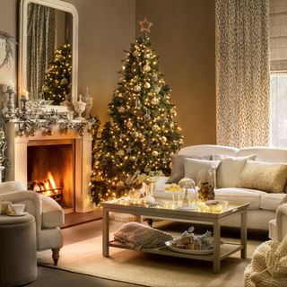 Cosy Christmas living room with cream corner sofa and light brown walls