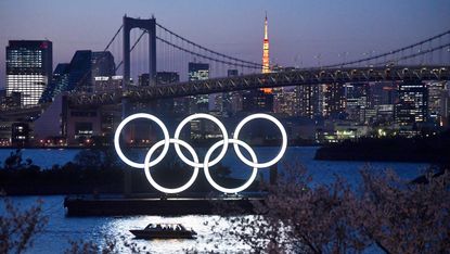 A boat sails past the Tokyo 2020 Olympic Rings on March 25, 2020 in Tokyo, Japan.