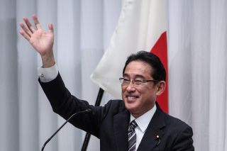 Japanese Prime Minister Fumio Kishida waving at an event
