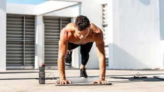 a photo of a man doing high plank with leg lifts