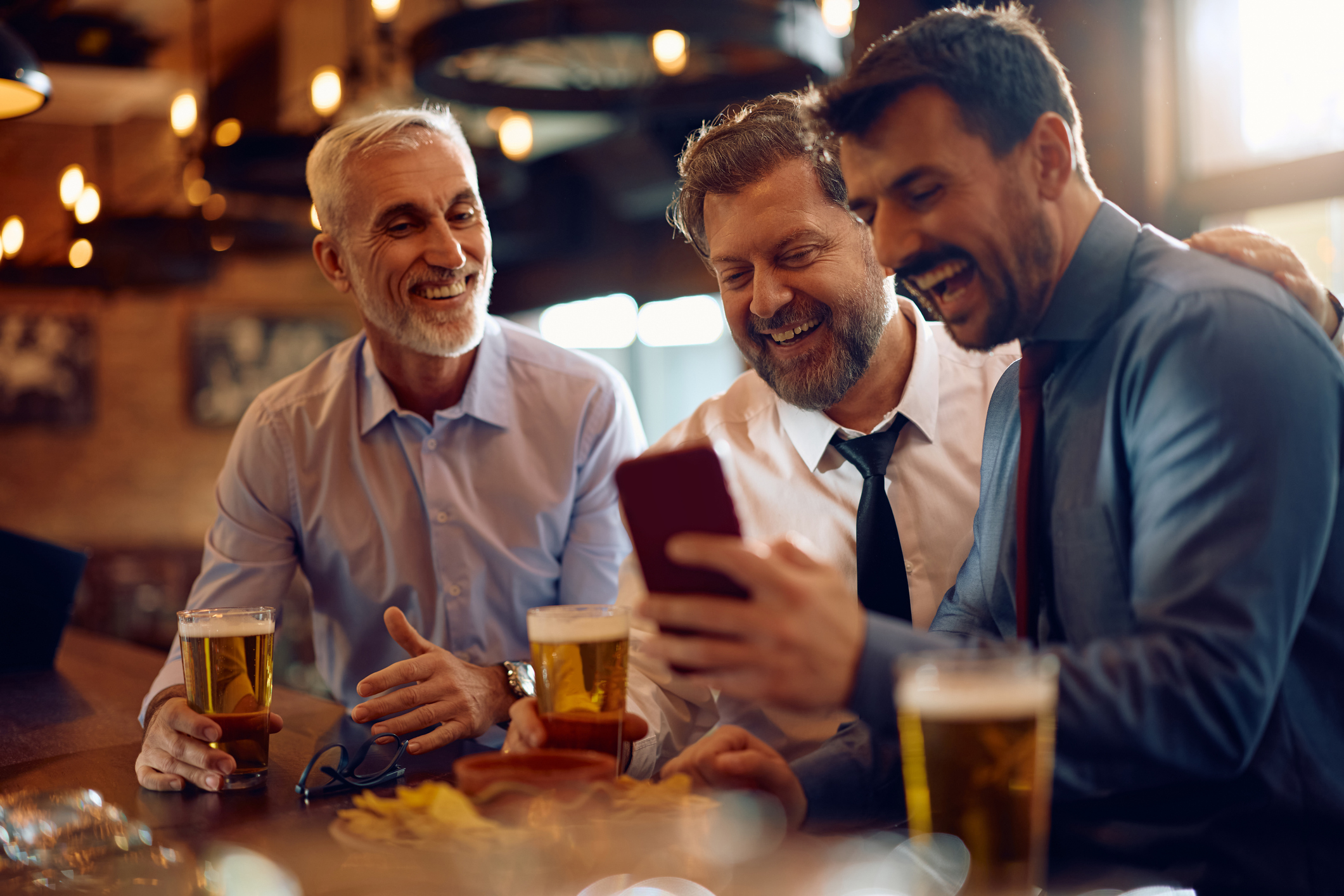 Investment club concept of men in pub discussing stocks