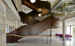 A sculptural steel and oak staircase elegantly cantilevers through a three storey atrium, landing by the centre’s new visitor reception.