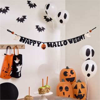 Ed Emberley Happy Halloween Garland against a white wall.