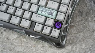 A gray GravaStar Mercury K1 Pro mechanical keyboard, with spider legs