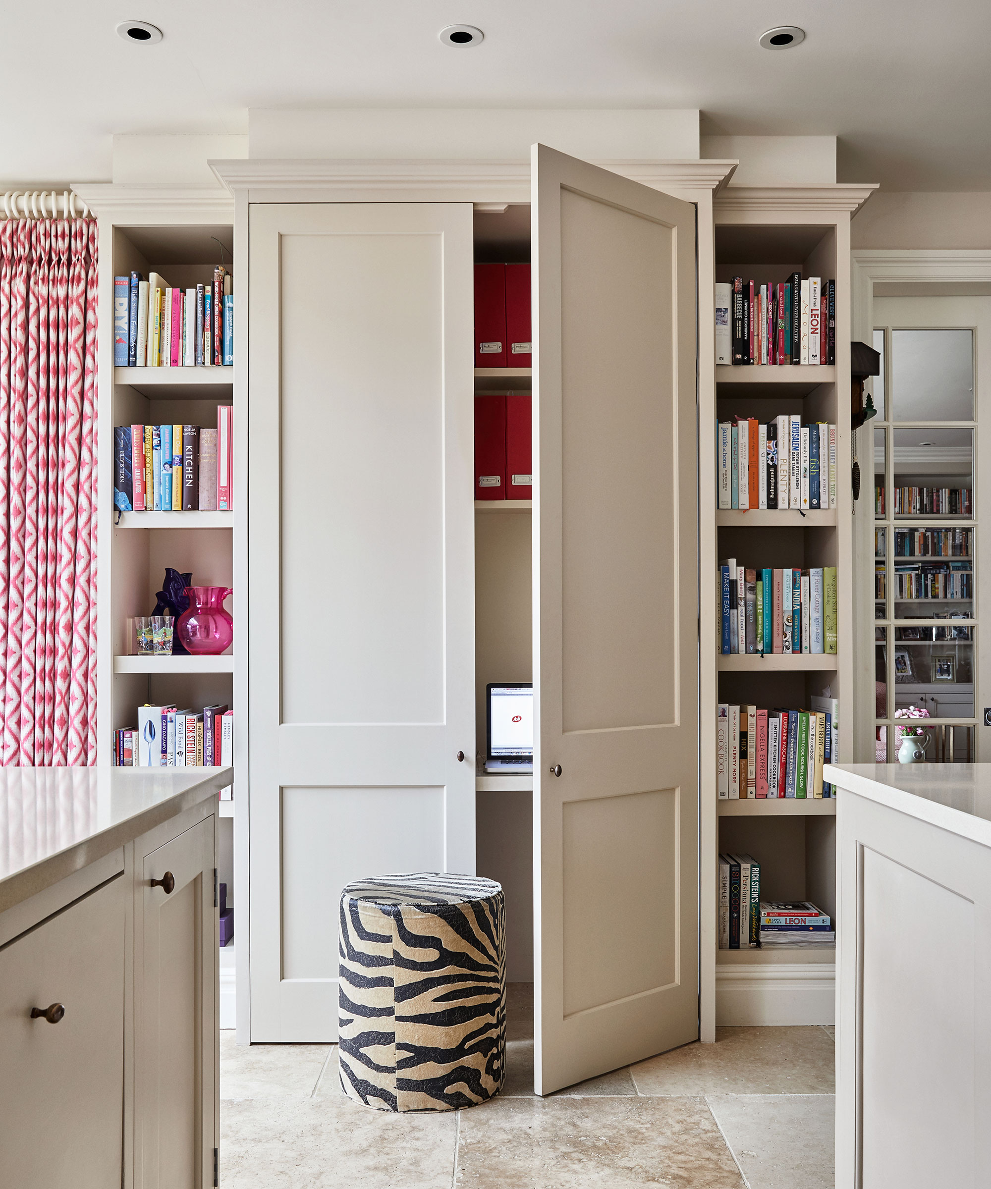 Bespoke built-in storage in neutral hues offering desk space and bookshelves.